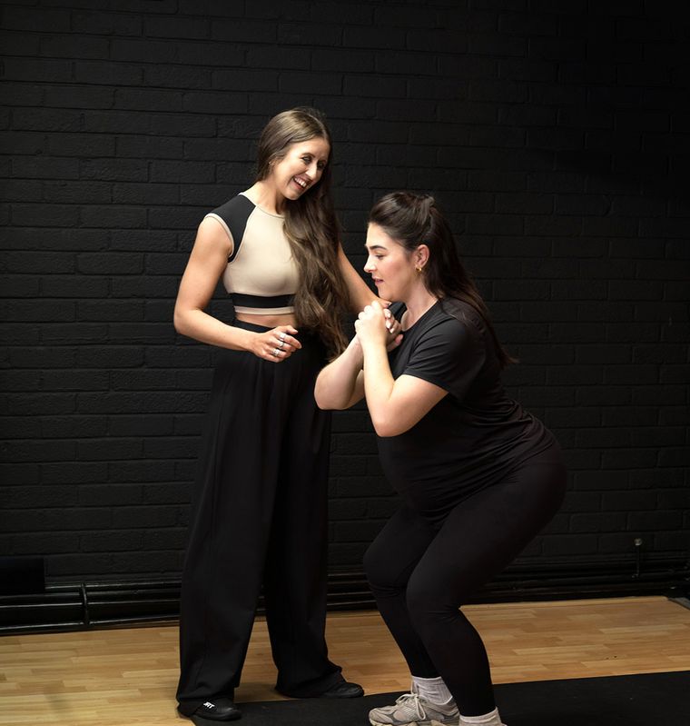 Elin Wyn laughing with a pregnant client between exercises