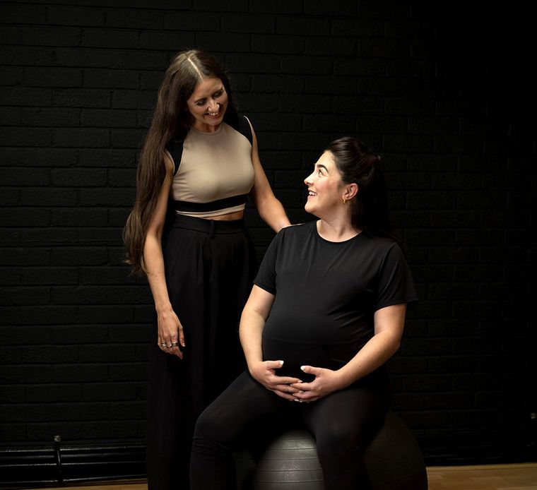 Elin Wyn in conversation with a pregnant client on an exercise ball